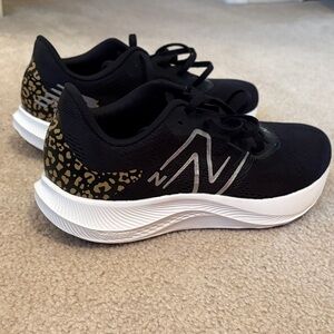 New Balance Women's Black Athletic Sneakers with Gold Leopard Print Accent